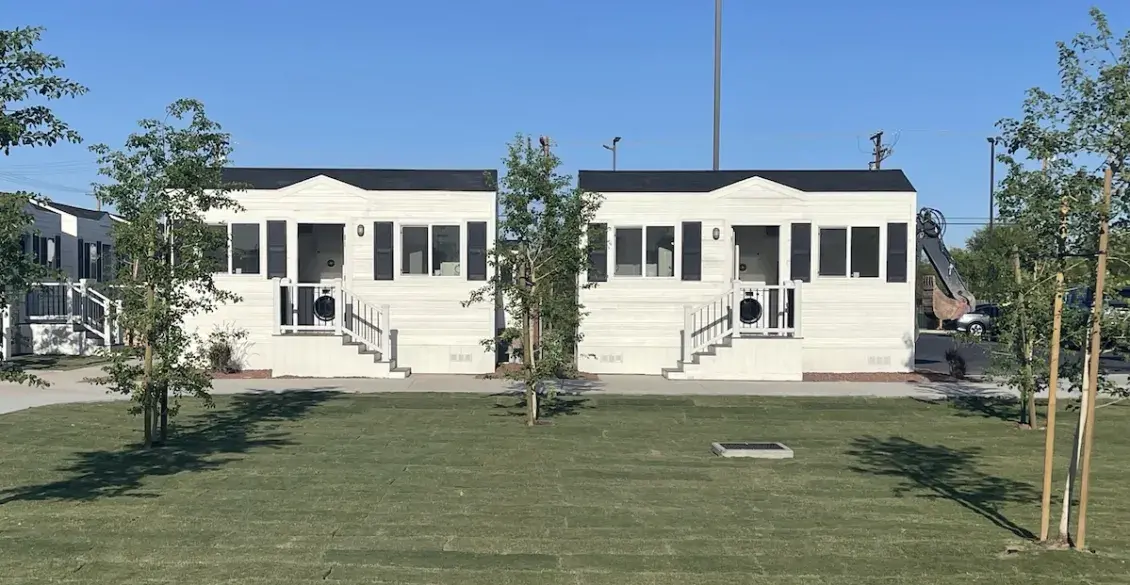 Photo of trees, lawn and white homes
