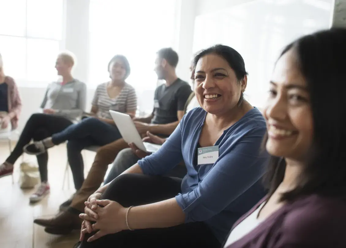 Seated woman smiling amid others