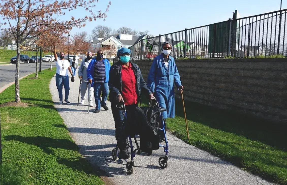 People walking down sidewalk