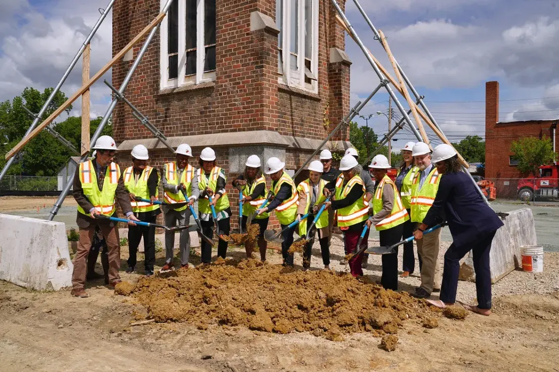 People with shovelings digging into dirt