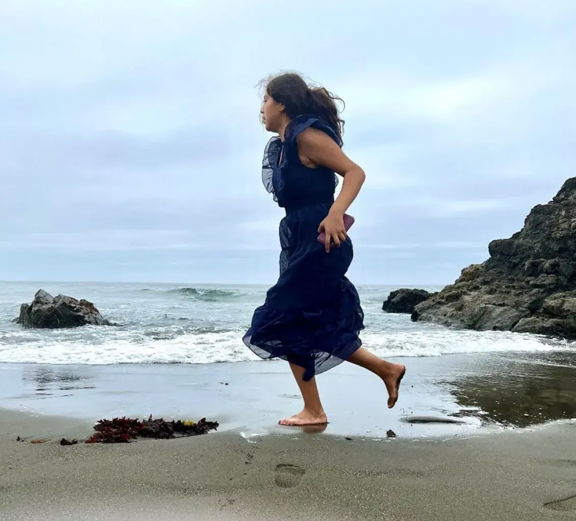 Woman from tribe dancing on the beach in California