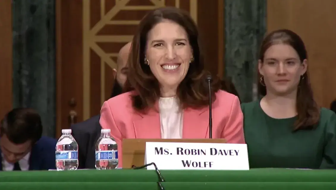 Picture of smiling woman in peach blazer