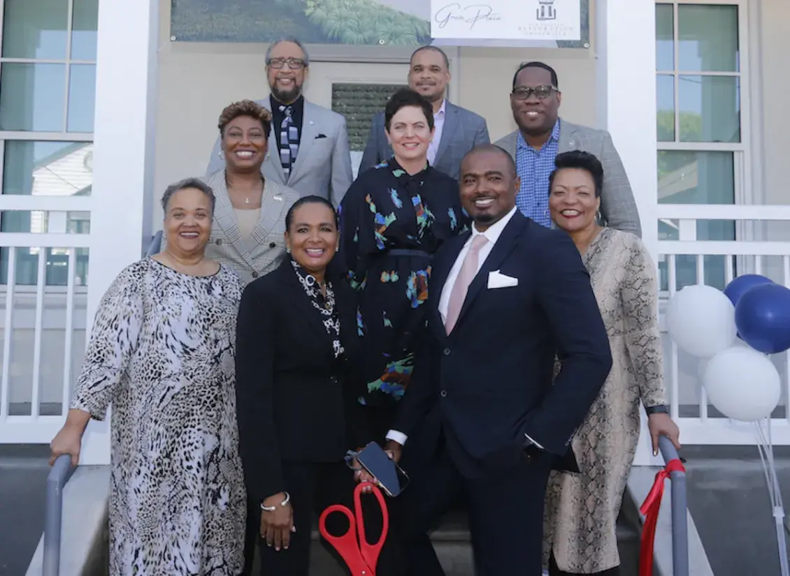 People standing on stairs of new home 