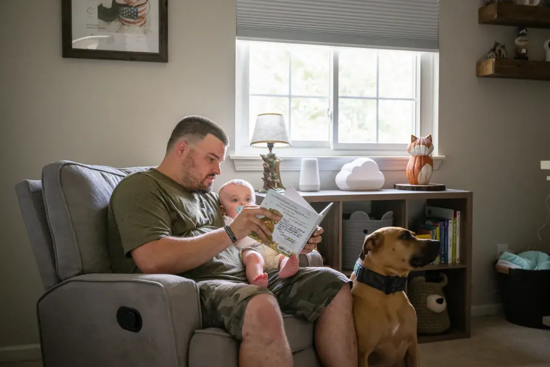 Veteran reading book to child