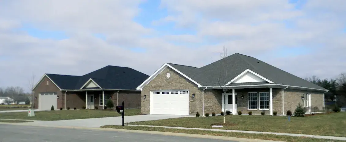 Two single family homes with green lawns