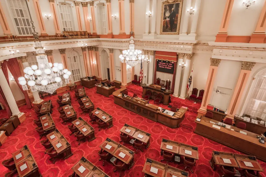California State Senate Chambers Interior with bright red carpet and desk
