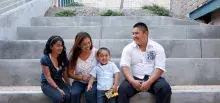 Family sitting on stairs; man, woman and two children