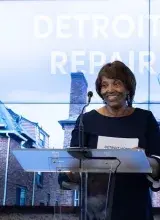 Woman standing behind podium