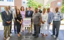 Picture of people standing around podium