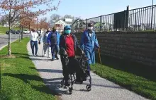 People walking down sidewalk