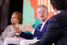 Shaun Donovan, Incoming CEO and President, sitting and speaking on stage 