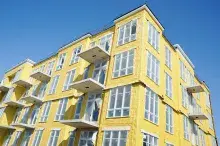 Yellow blown insulation on a new condominium or apartment building in construction