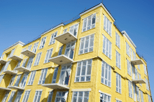 Yellow blown insulation on a new condominium or apartment building in construction