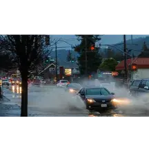 Cars driving through a flooded street in Ukiah, California