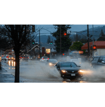 Cars driving through a flooded street in Ukiah, California
