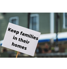 Sign with the words "Keep families in their homes" printed on it