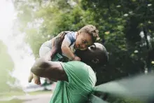Man holding up baby