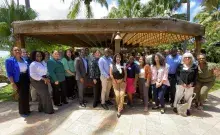 A group of people stand at a gazebo