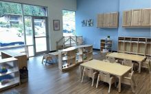 Small desk and chairs for small children in bright blue room