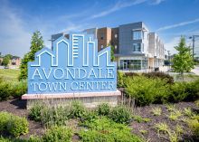 A photo of a sky blue city shaped sign that says Avondale Town Center