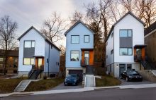 Three modular homes from the Black Street Project on a neighborhood block