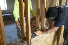 Construction workers install hempcrete installation