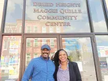 A man and a woman stand in front of the Druid Heights Maggie Quille Community Center
