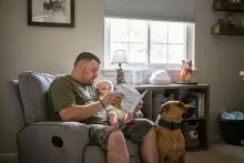 Veteran reading book to child