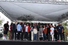 Group of smiling people standing on a stage