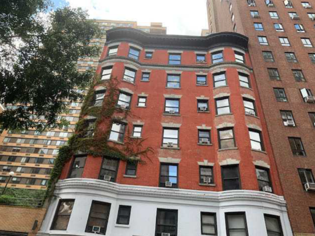 A red brick and stone colored apartment building in New York