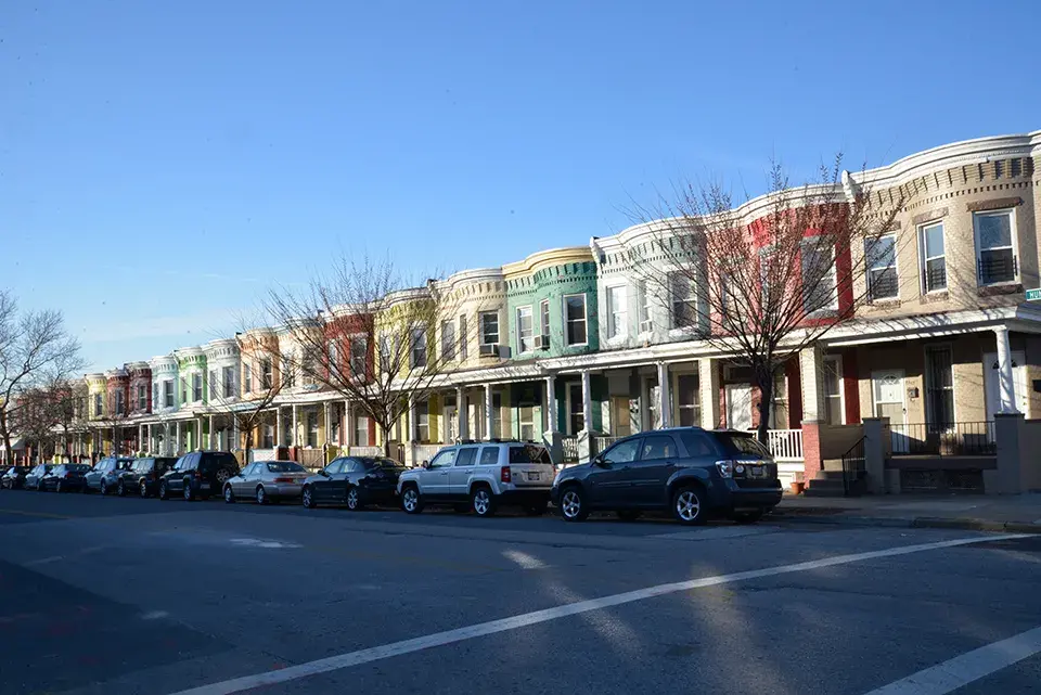 Multi-colored homes line the street of a neighborhood