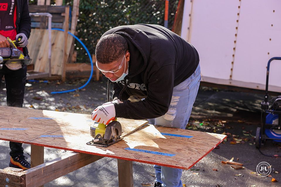 A person cutting wood with a table saw
