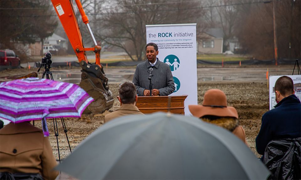 A man speaking at a podium outside during a groundbreaking ceremony