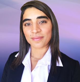 Person with straight long dark hair wearing a white blouse and a dark blazer.