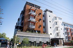 Streetview of Kifer Senior Apartments in Santa Clara with people passing by on the sidewalk