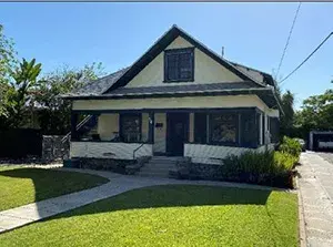 Front view of Wilson House, a yellow two-story home