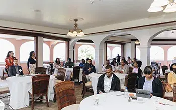 Attendees of Housing Our Community event in St. Croix, USVI seated at round tables in a meeting room. Credit: Nicole Canegata