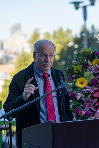 Man in suit and tie speaking at podium