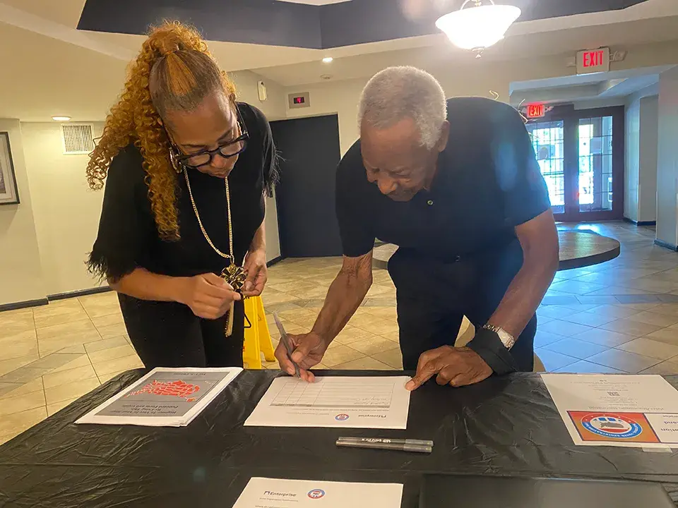 PV Coldspring Monique helping another resident complete the sheet correctly