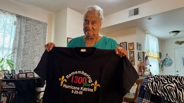 Emelda Paul holds a t-shirt