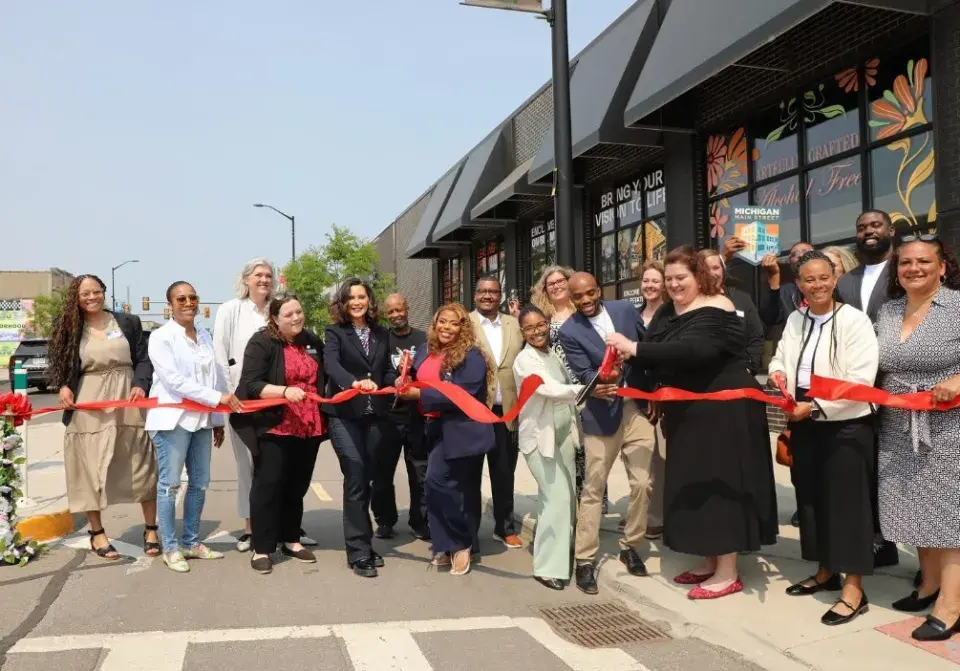 A group of people cutting the ribbon 