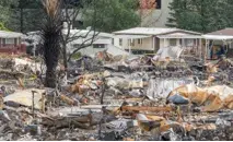 Homes destroyed by a natural disaster surrounded by debris and devastation