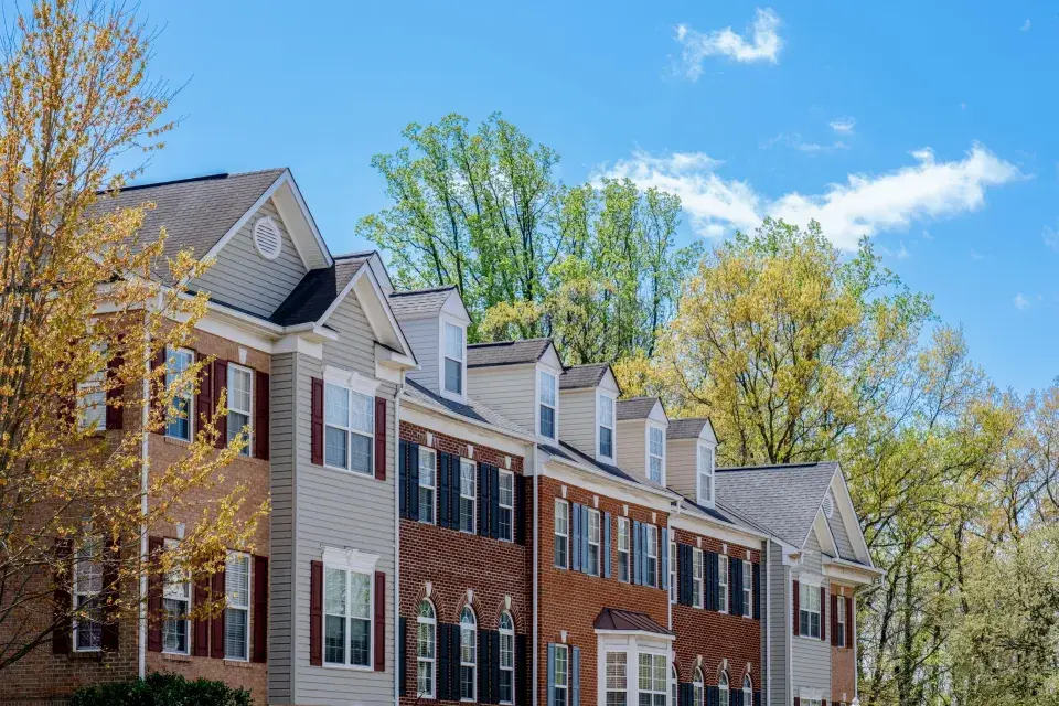 A street lined with multifamily housing framed with trees