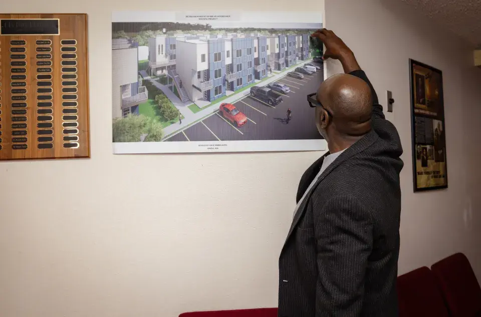 Pastor Will Mitchell surveys plans for affordable homes