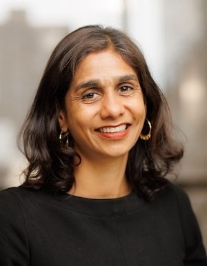 Smiling woman with shoulder length brown hair and black sweater