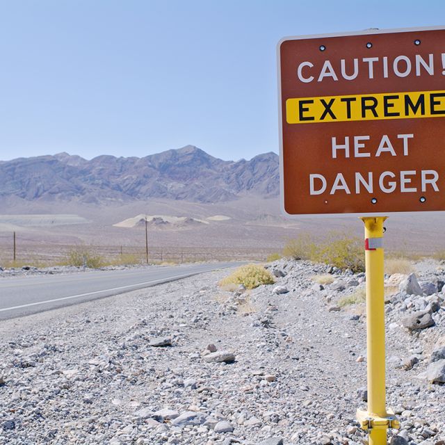 Caution sign warning of extreme heat and danger in the desert 
