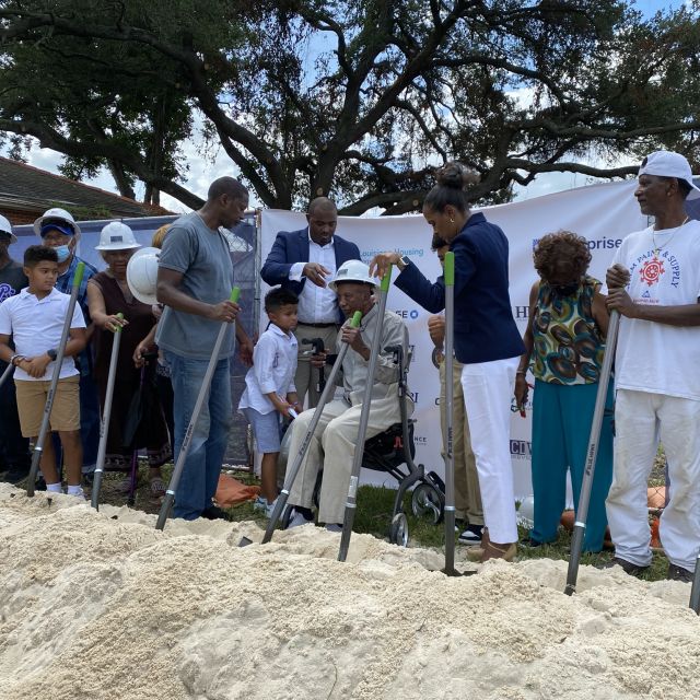 People stand at a groundbreaking for a property in New Orleans