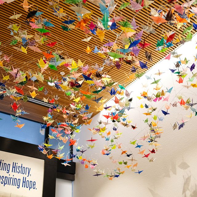 Multi-colored origami cranes hang from the ceiling of Hirabayashi Place in Seattle