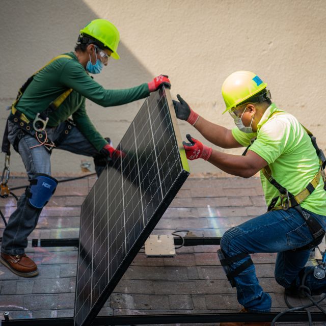 Men installing solar panels