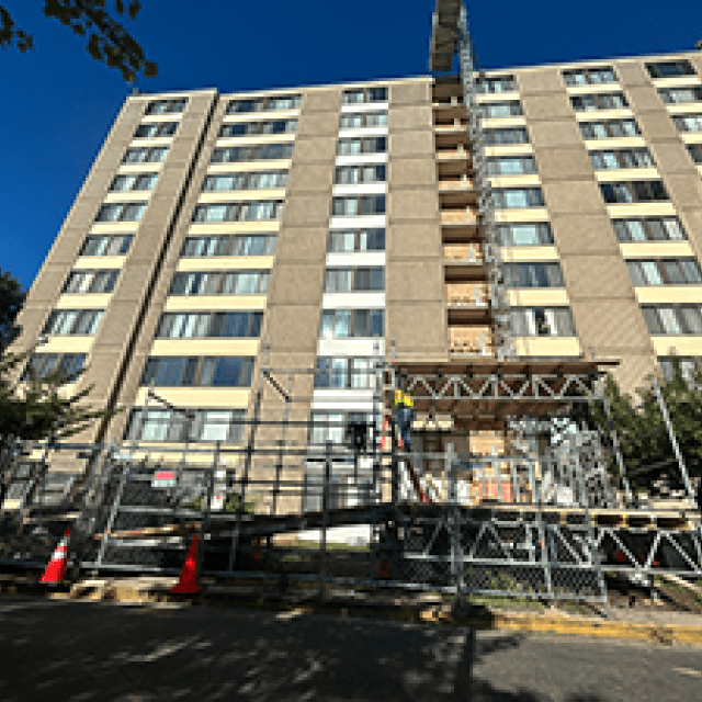 Skyward view of an apartment building with scaffolding in front